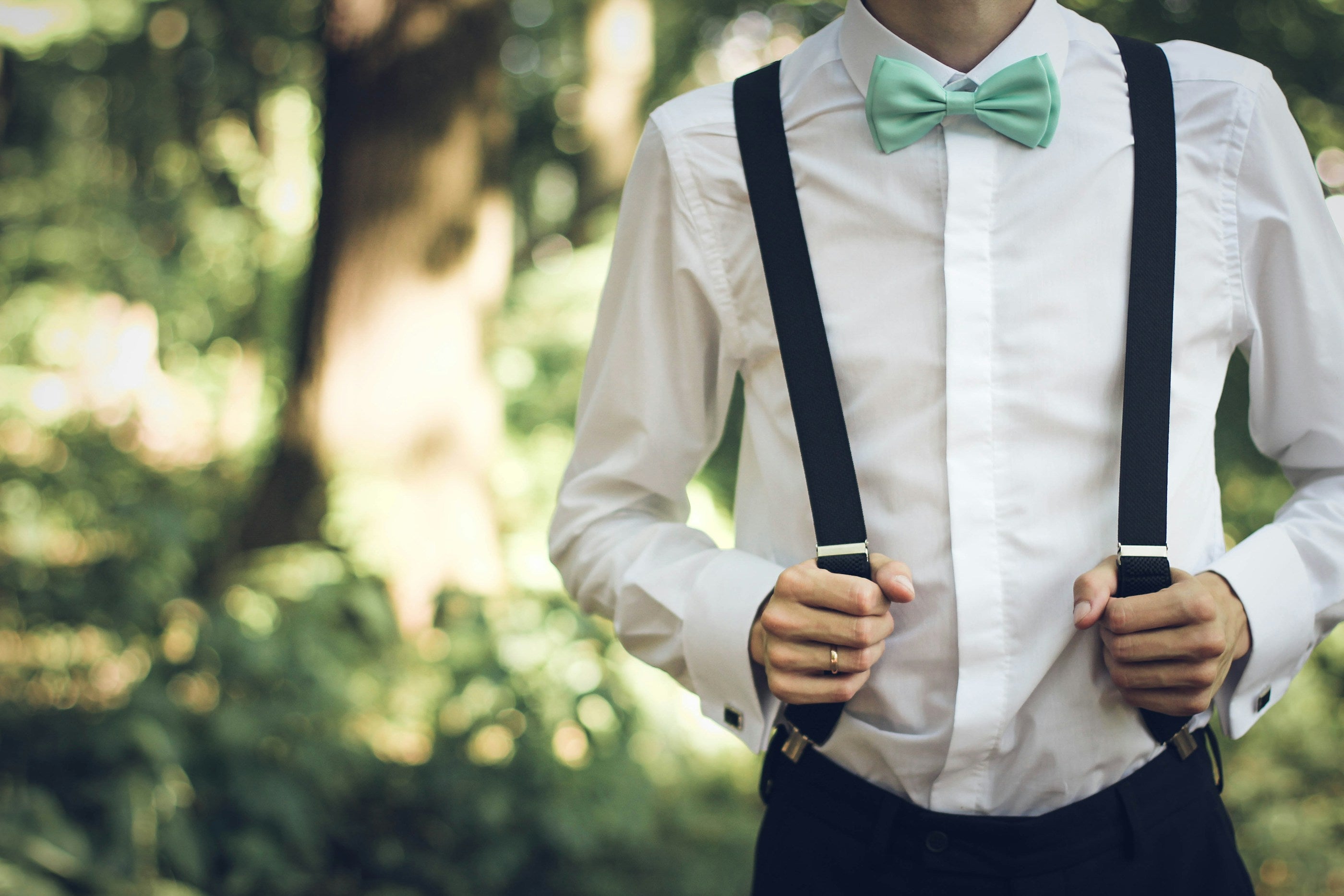 Man in a white dress shirt wearing suspenders