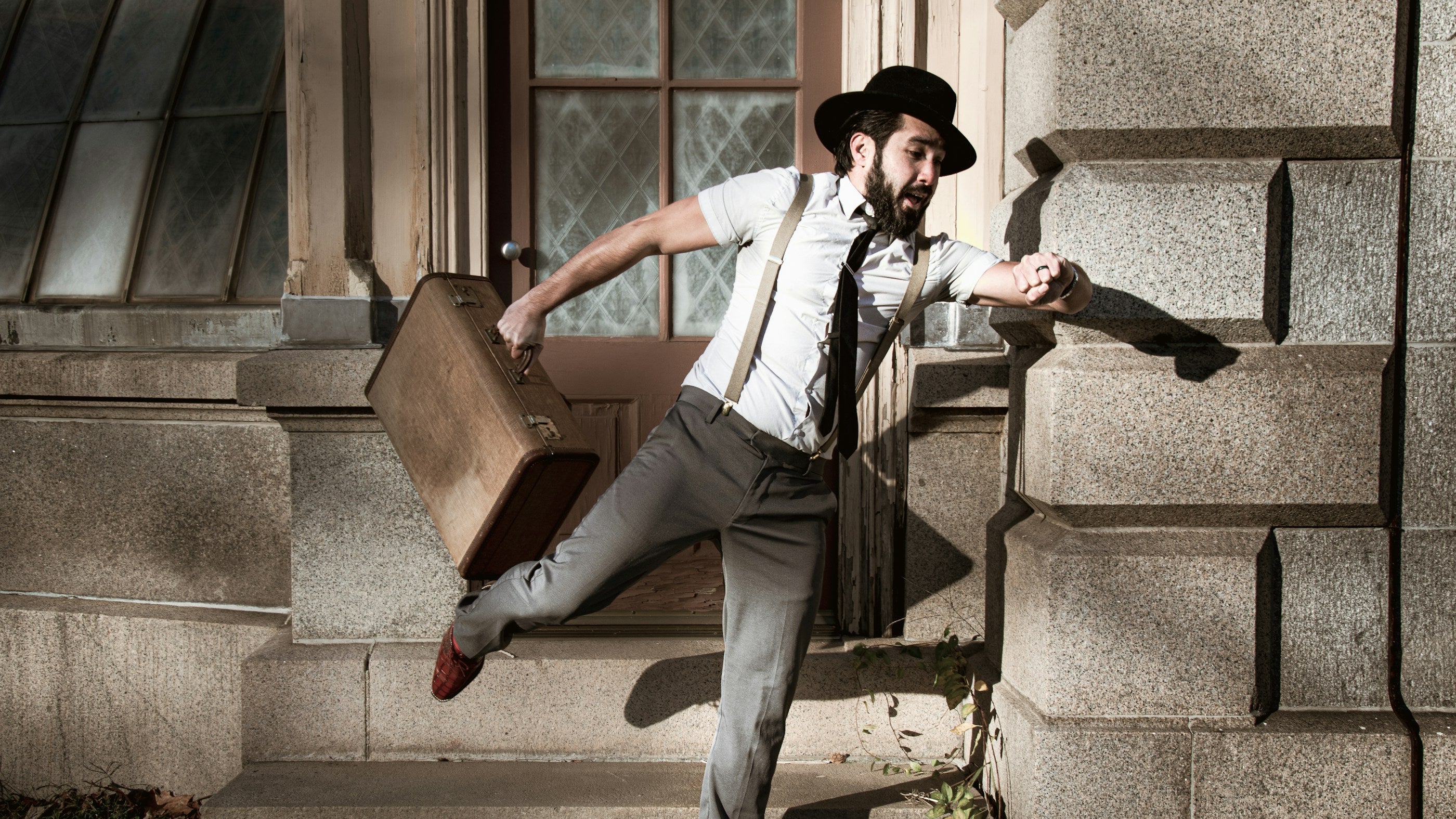 Man in a white dress shirt and suspenders