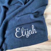 Personalized knit baby blanket in a stroller