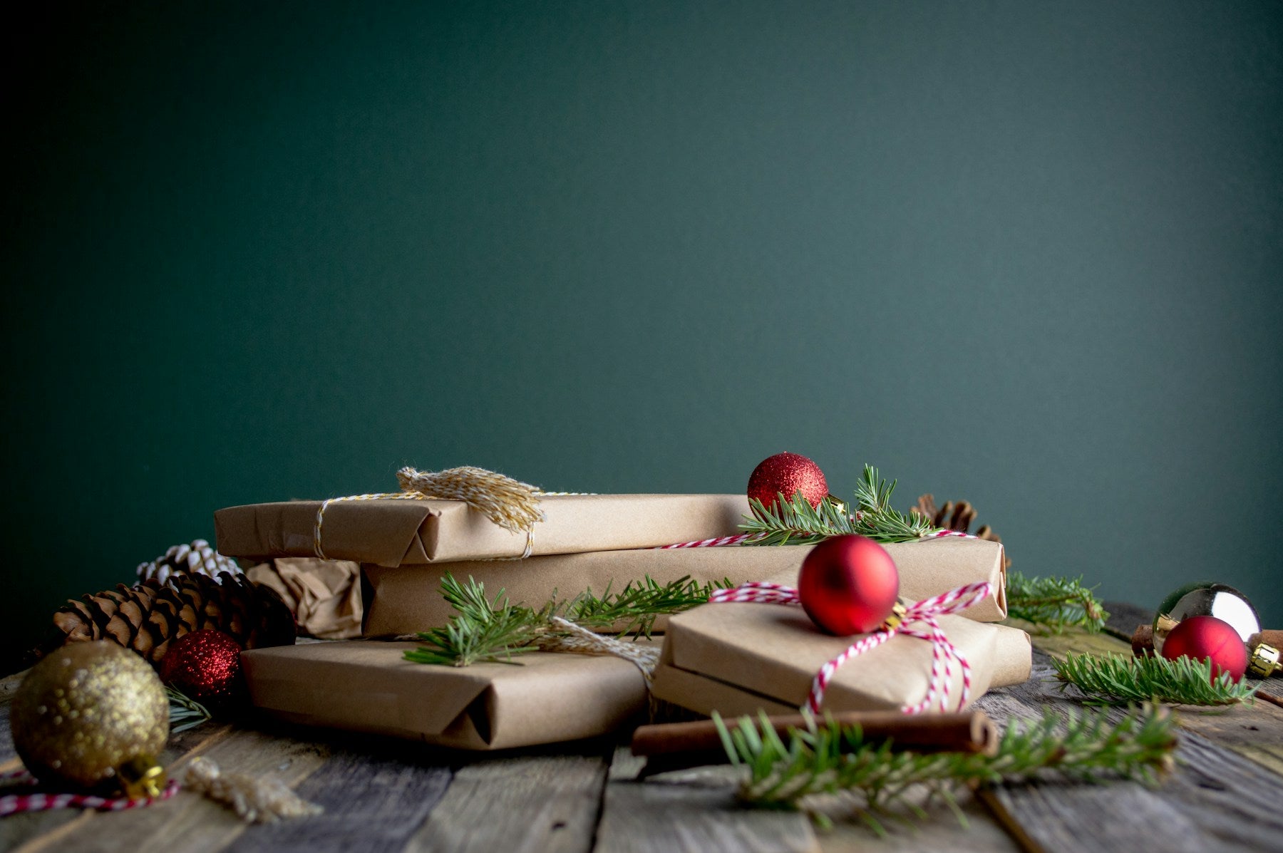 Christmas gift boxes topped with red ornaments